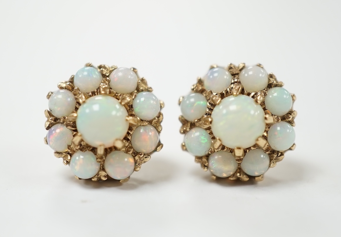 A pair of yellow metal and white opal set flower head cluster earrings, 10mm, 3.3 grams. Condition - fair
